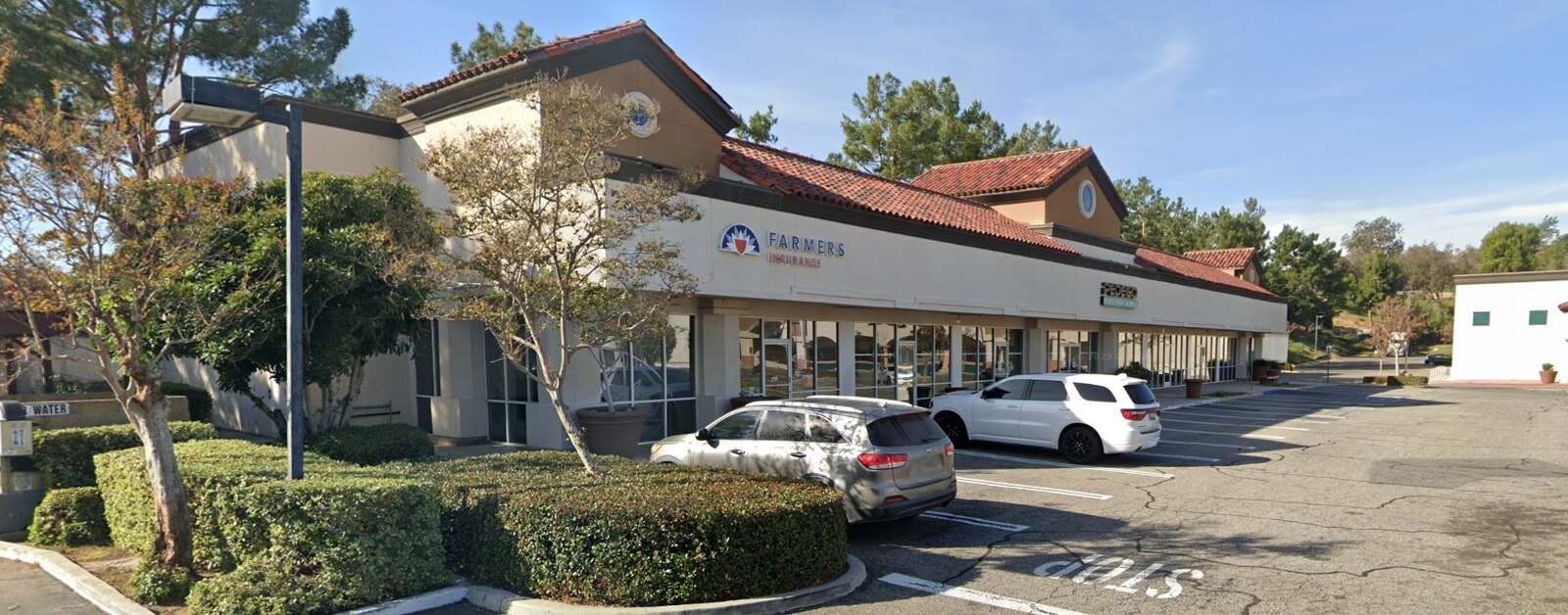 Wide exterior view and parking area of the Yorba Linda insurance office